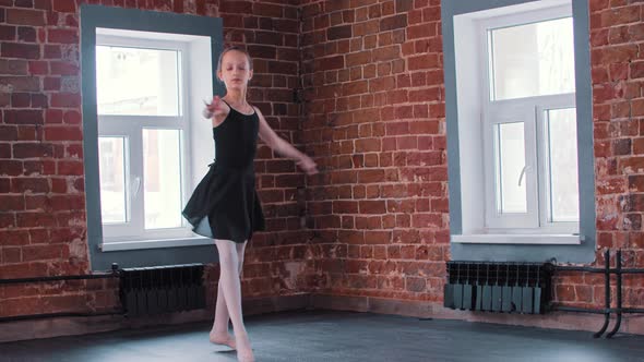 Ballet Dancing  a Little Gymnastics Girl Dancing in Black Suit on Training and Performing Pirouettes