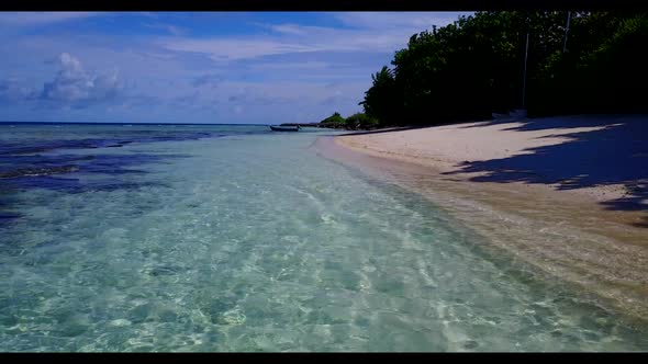 Aerial drone shot scenery of tranquil resort beach break by transparent sea and clean sandy backgrou