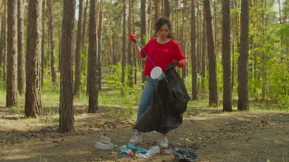 Asian Female Volunteer Cleaning Forest Garbage