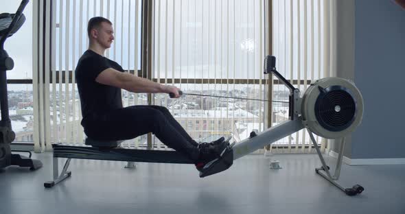 A Man Goes In For Sports In The Gym. Exercises On A Dam Simulator