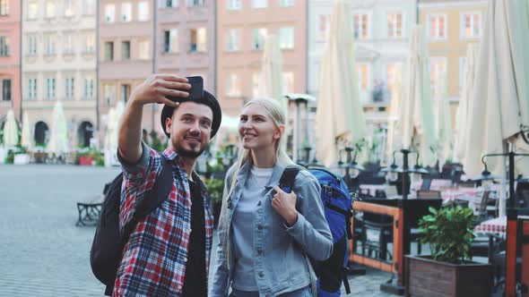 Happy Young Couple of Tourists Making Selfie on Smartphone in the City Center