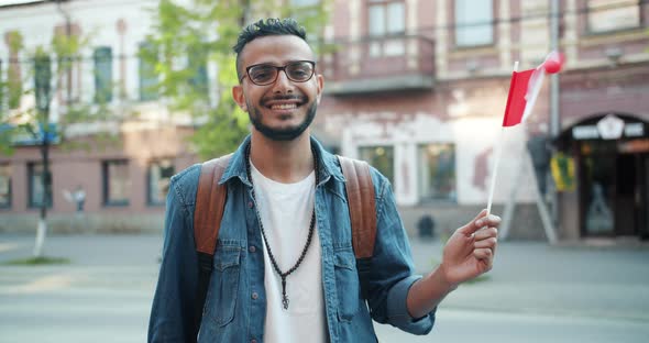 Portrait of Attractive Abarian Guy Holding Canadian Flag in the Street Smiling