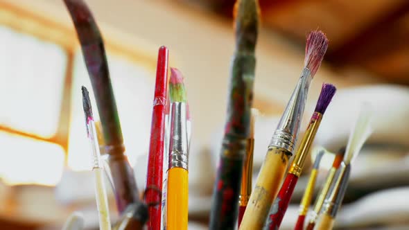 Close-up of various paint brush in pencil holder 4k