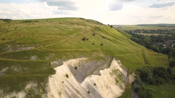 Aerial view of a hill side with big rocky slope from gravel stones.