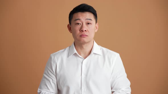 Confident Asian businessman giving positive answer