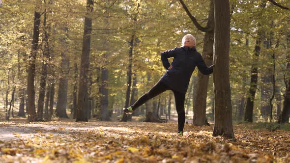 Healthy Old Woman Doing Sports Exercises in Nature