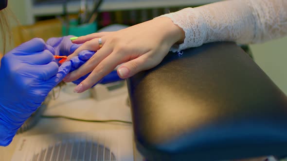 A Woman Gets a Manicure in a Beauty Salon