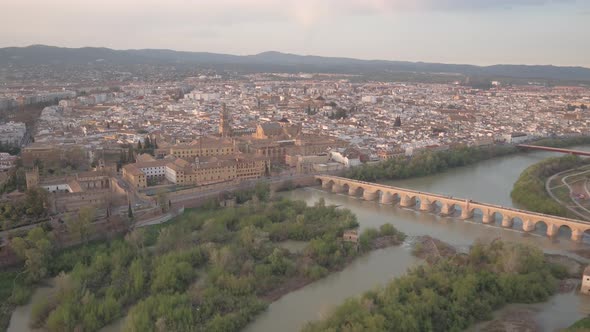 Aerial of Cordoba with the Roman bridge across a river