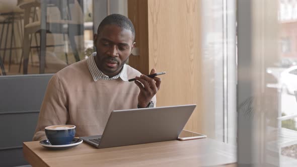 Afro American Businessman Working in Cafeteria