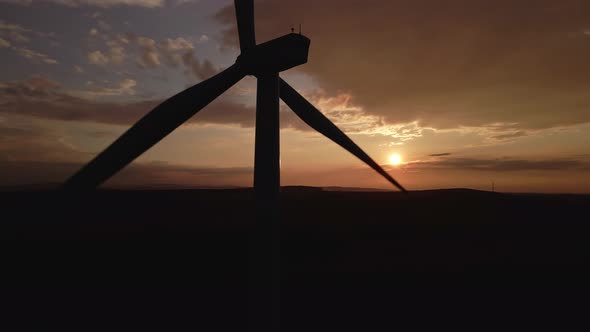 Silhouette of Windmill Turbine in Field at Sunset Sky