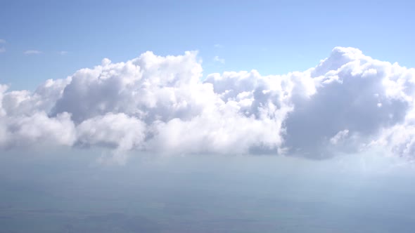 View of White Cumulus Clouds in the Bright Rays of the Sun