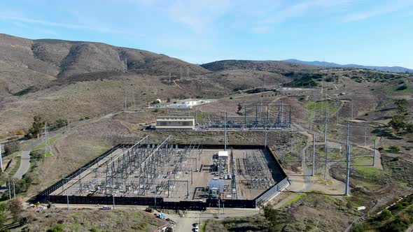 High Voltage Power Electric Station with Dry Mountain Background