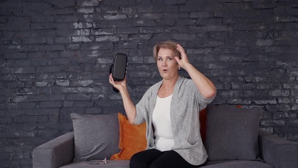 Senior Woman Using 3d Glasses Helmet at Home