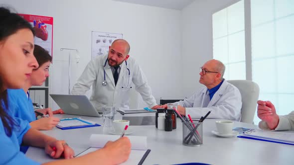 Medical Staff Talking with Teamworker in Hospital Office