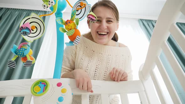 POV Shot of Baby Looking on Smiling Mother Playing with Him in Crib