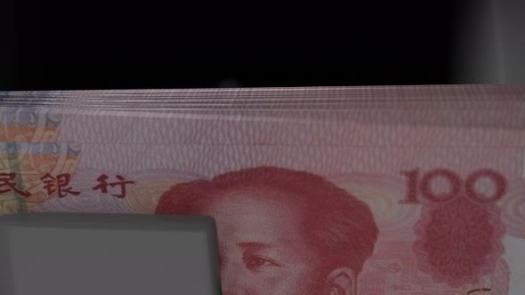 100 Chinese Yuan in cash dispenser. Withdrawal of cash from an ATM.