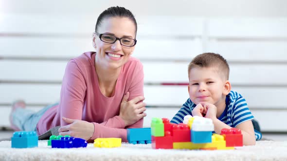 Medium Closeup Smiling Beautiful Young Mother Woman and Little Cute Son Boy Looking at Camera
