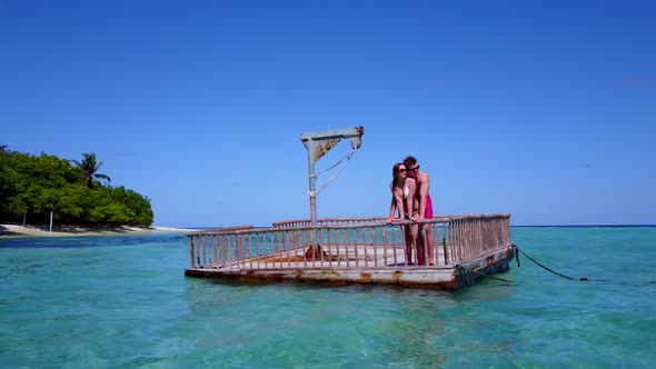 Family of two in love on tranquil coast beach time by blue sea with white sandy background of the Ma