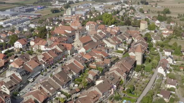 Aerial side overflight of Avenches medieval town and Roman arena