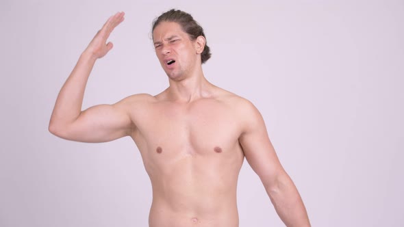 Frustrated Muscular Shirtless Man Getting Bad News