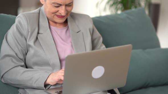 Beautiful Happy Business Woman with Short Haircut Working Remotely From Home