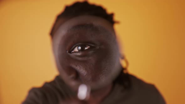 Portrait of an African Man Looking Through the Magnifying Glass