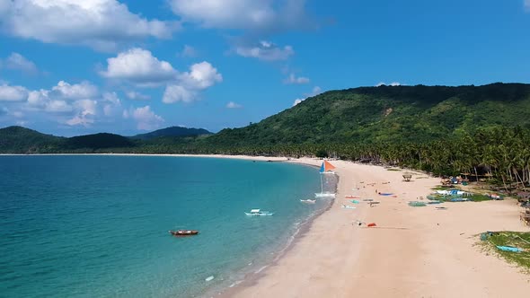 Low flying aerial over Nacpan beach, El Nido , Palawan, Philippines