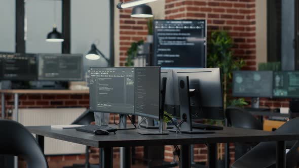 Computer Screens Running Programming Code in Empty Software Developing Agency Office