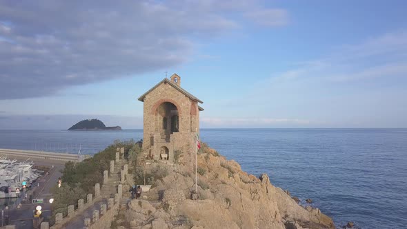 Aerial view of chapel in Alassio, Liguria, Italy. Revealing Gallinara island