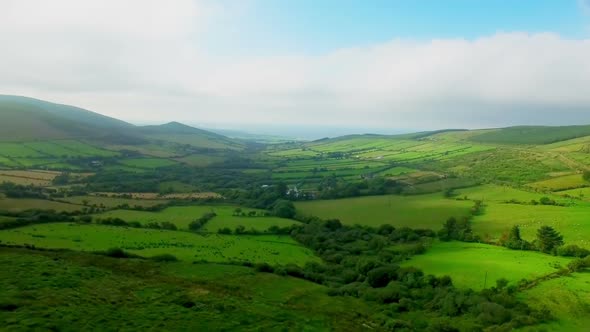 Green patchwork fields on the hills