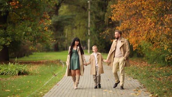 A Happy Family is Walking in the Park