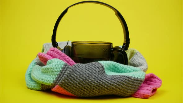 Brown Mug with Hot Drink, Warm Striped Sweater and Headphones. Stop Motion Animation