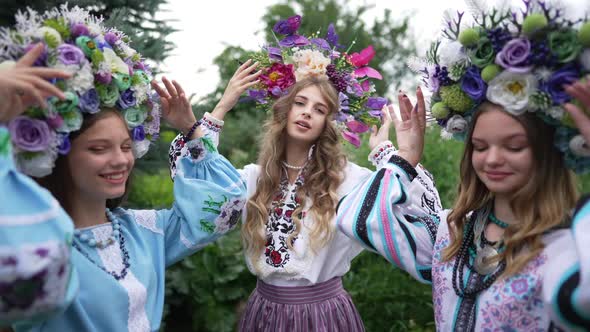 Gorgeous Confident Woman Posing in Traditional Ukrainian Head Wreath and National Dress with Friends