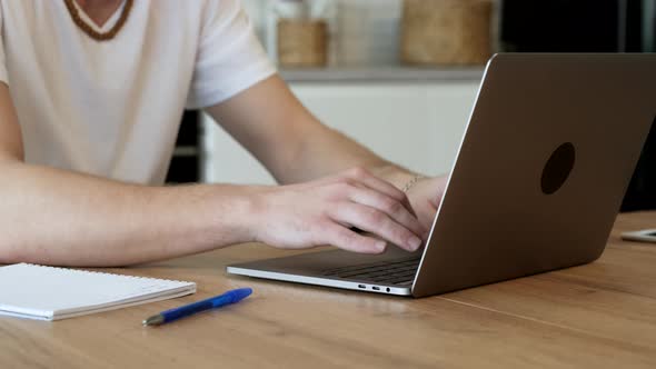 Man communicating in social network, searching information online, typing words