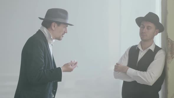 Two Adult Confident Men in Fedora Hat Standing in the Broken Dirty Place and Talking