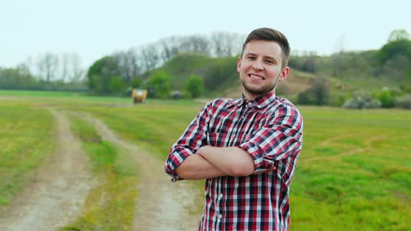 Portrait of Successful Agronomist Man Looking To Camera in the Green Wheat Field