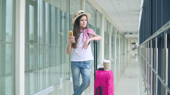 Little Girl Eat Fast Food and at the Airport While Waiting for the Plane