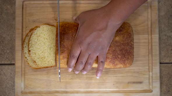 African American woman slicing homemade bread, Overhead Close Up on hands