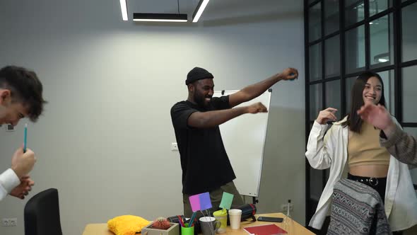 Cheerful IT Freelancers Dancing in Coworking Space