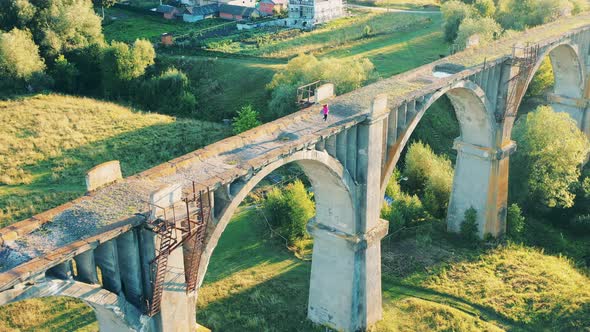 Top View of an Abandoned Bridge with a Female Runner on It