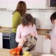 Down Syndrome Girls with Mother on Kitchen After Shopping - VideoHive Item for Sale