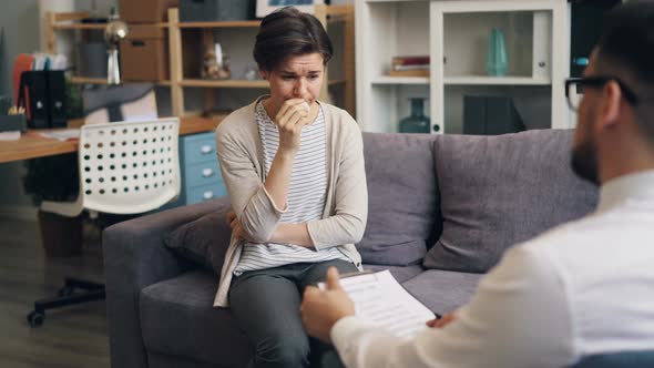 Upset Patient Crying During Personal Session with Psychologist in Office