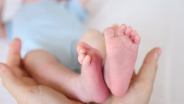 Close-Up Of Mother Holding Her Baby Feet