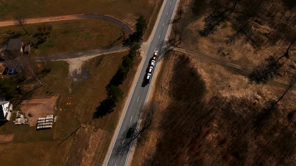 Large Car Transporting Truck with Many New Automobiles Driving Along Highway