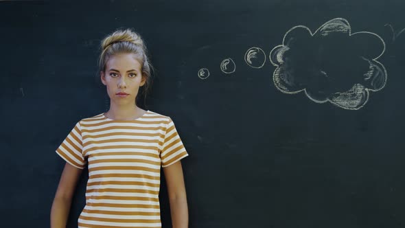 Portrait of woman in front of chalkboard