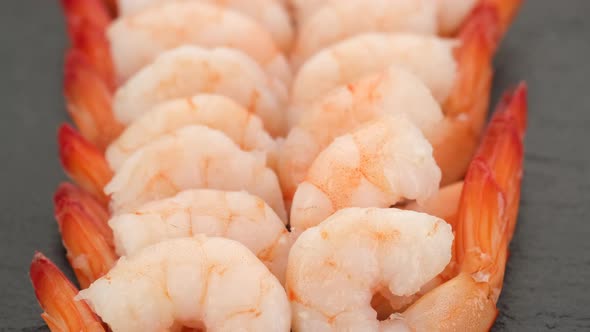 fresh shrimps close up on black plate