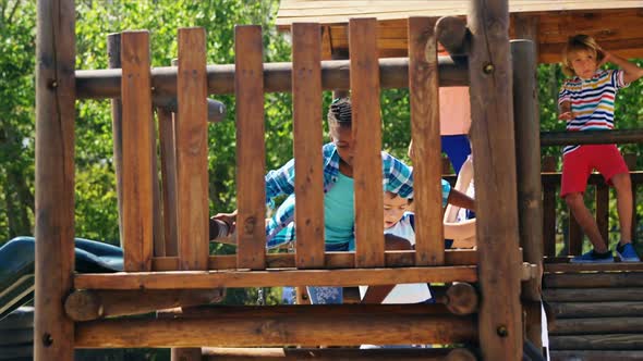 Schoolgirl playing on slide in playground