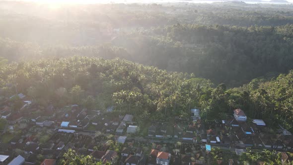 Sunrise over hillside with long sun rays pass through valley in village Bali, Indonesia