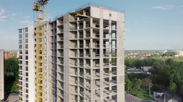 Aerial view of high residential apartment building under construction. Real estate development.