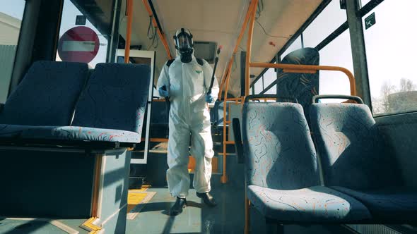 Sanitation Person Is Doing Chemical Treatment Inside of a Bus